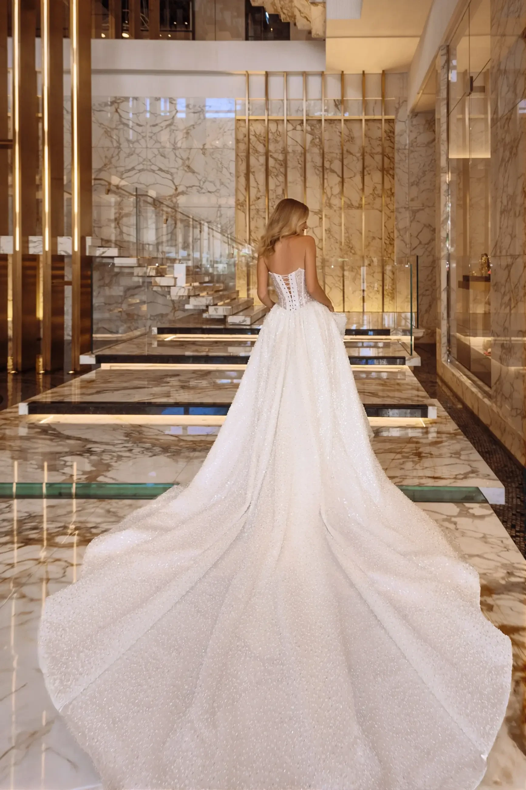 model is wearing a glamorous ball gown wedding dress