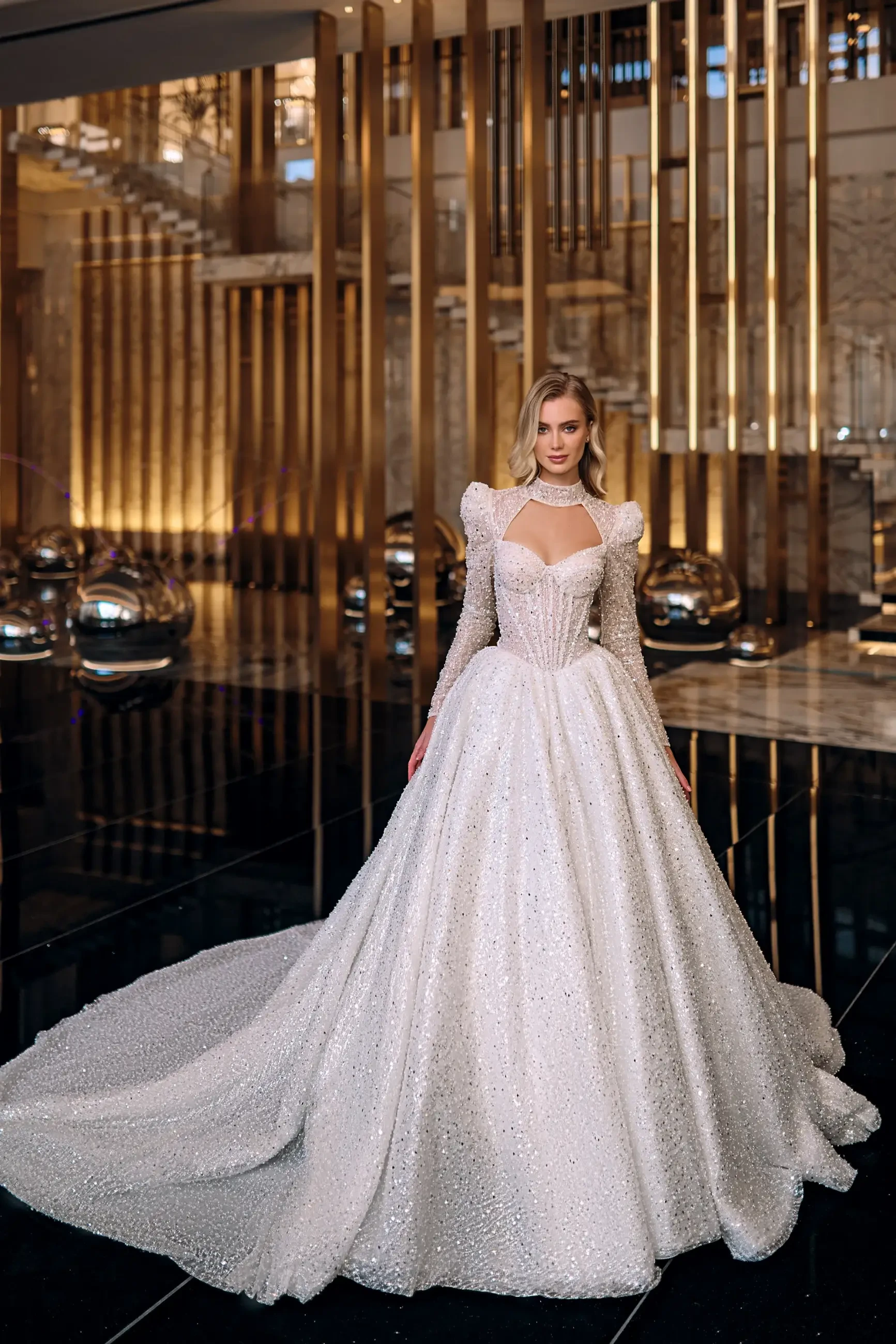 model is wearing a glamorous ball gown wedding dress