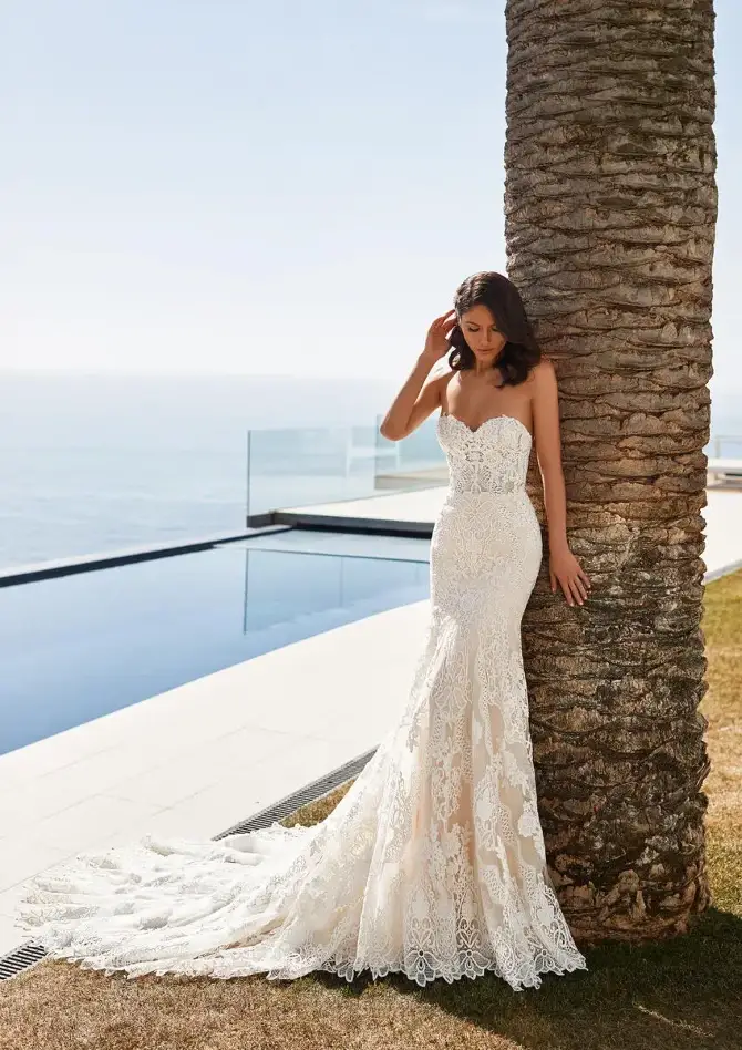 model is wearing a strapless fit and flare bridal gown