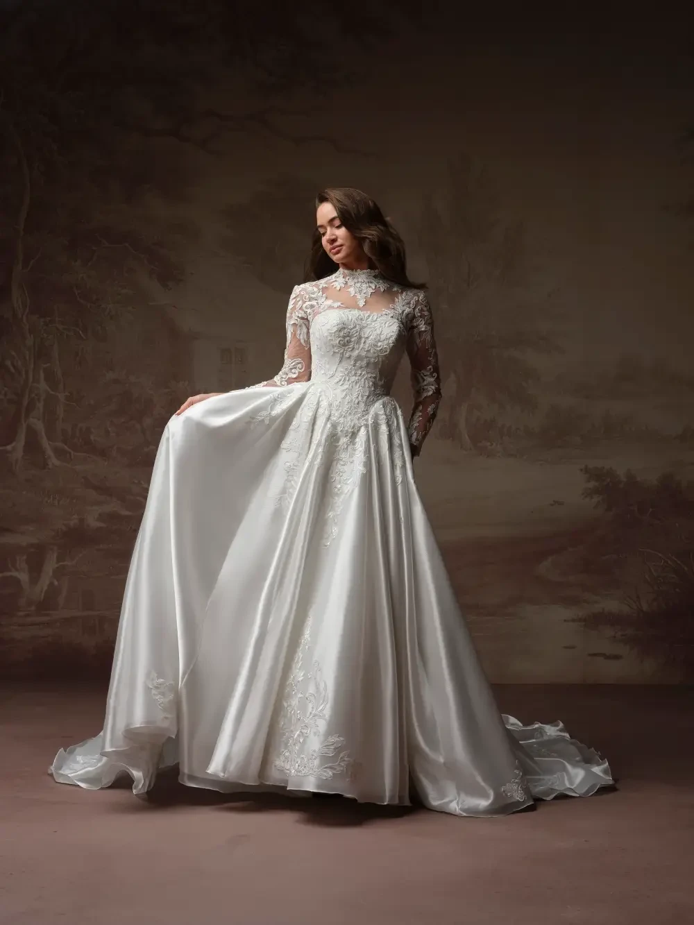 model is wearing a bridal gown with a dropped waist