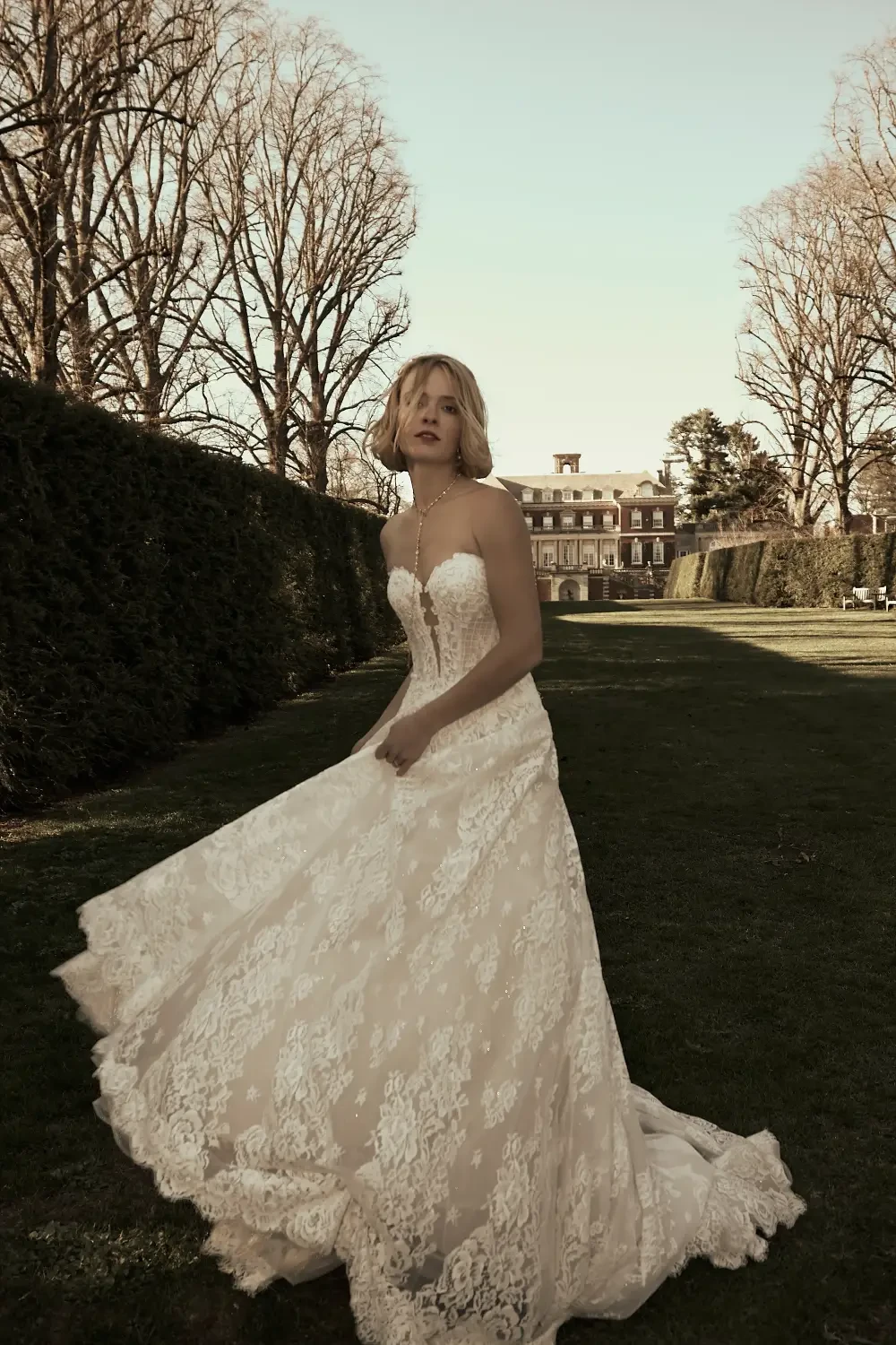 model is wearing a strapless lace a-line gown