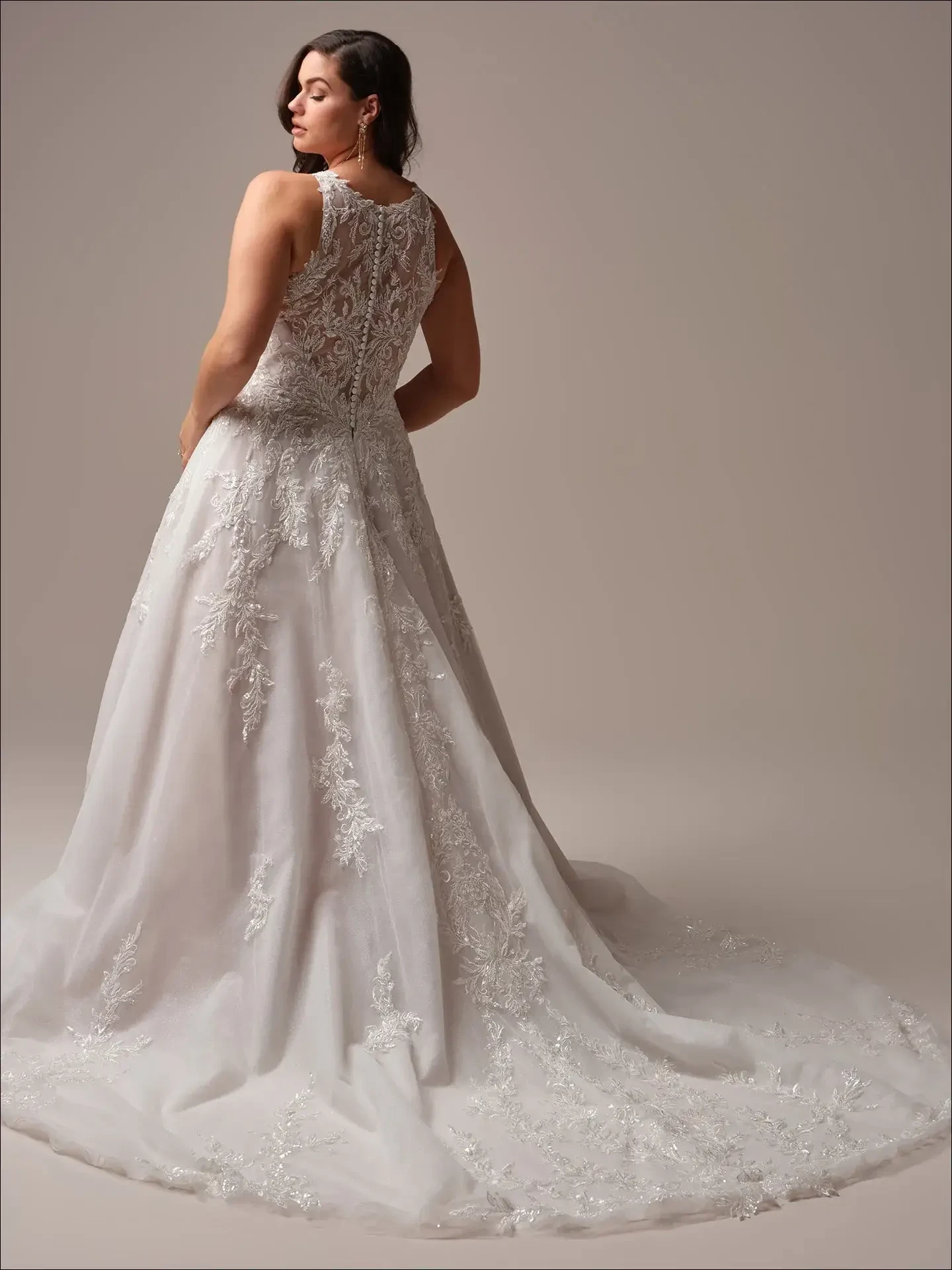 model is wearing a high neckline sleeveless plus size ball gown wedding dress