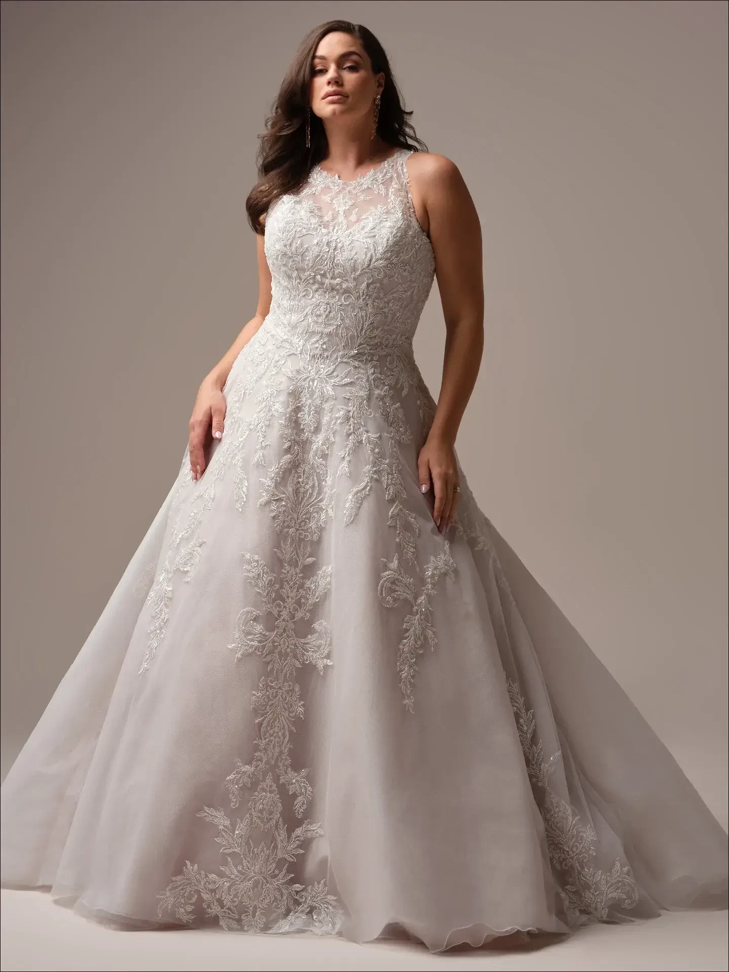 model is wearing a high neckline sleeveless plus size ball gown wedding dress